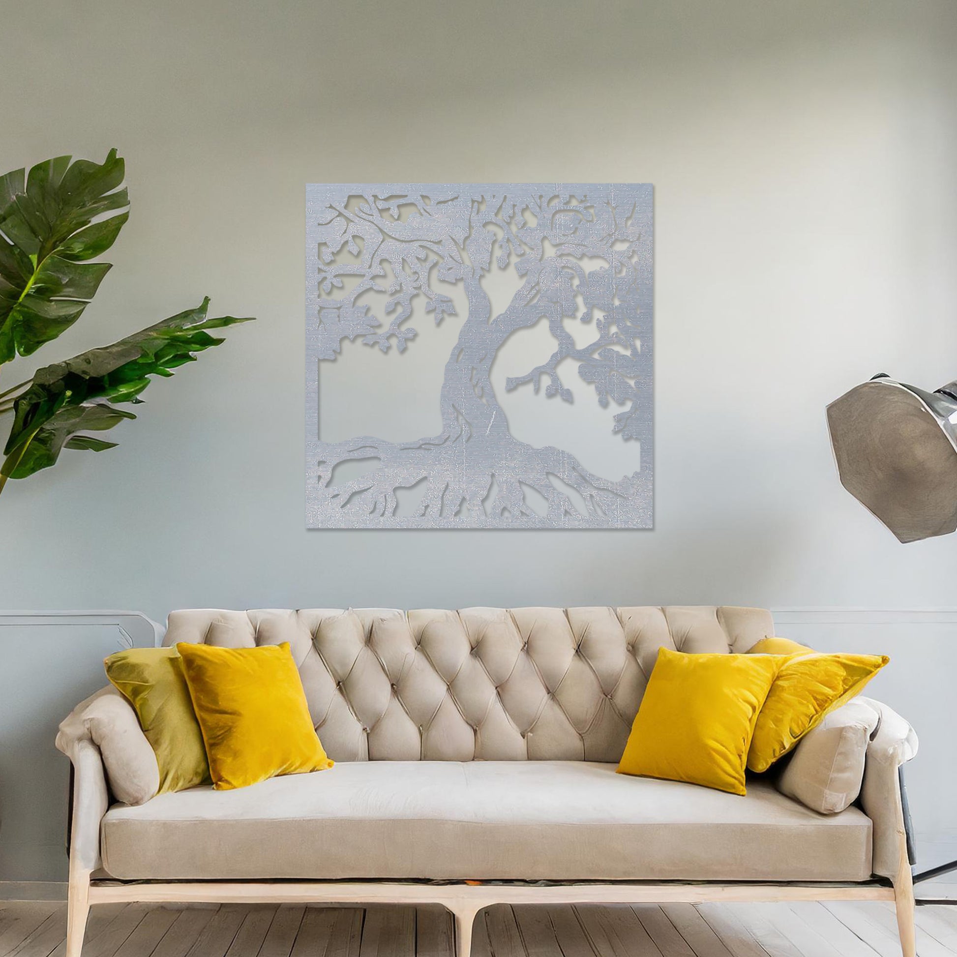 Wall art featuring a detailed tree of life design with sprawling branches and roots, symbolising growth and connection. The piece is displayed on a neutral wall within rustic-modern decor, adding a natural and meaningful focal point to the space.