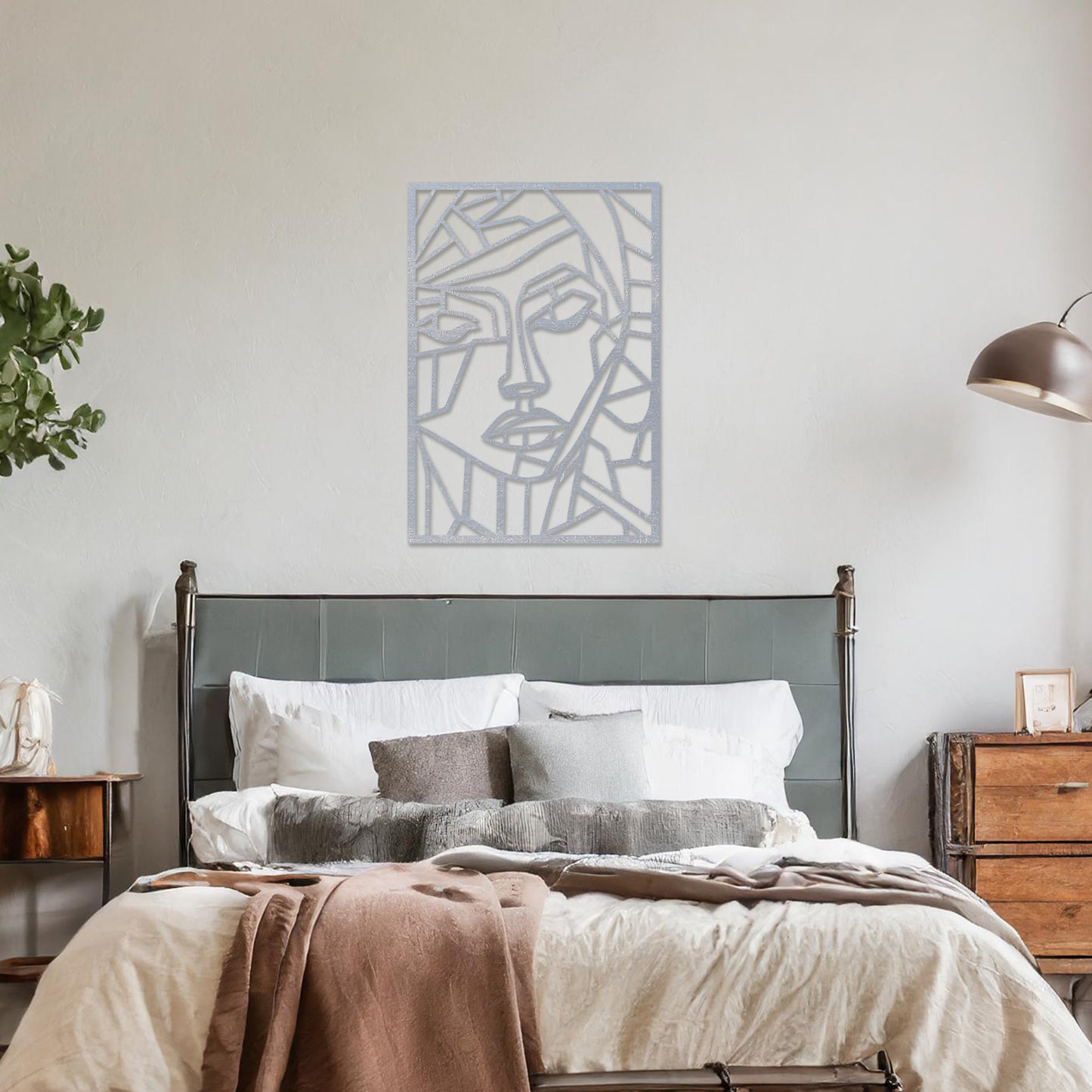A rectangular wall art piece featuring an abstract face design composed of geometric shapes and clean lines. The artwork is displayed on a neutral wall in a contemporary living room, 