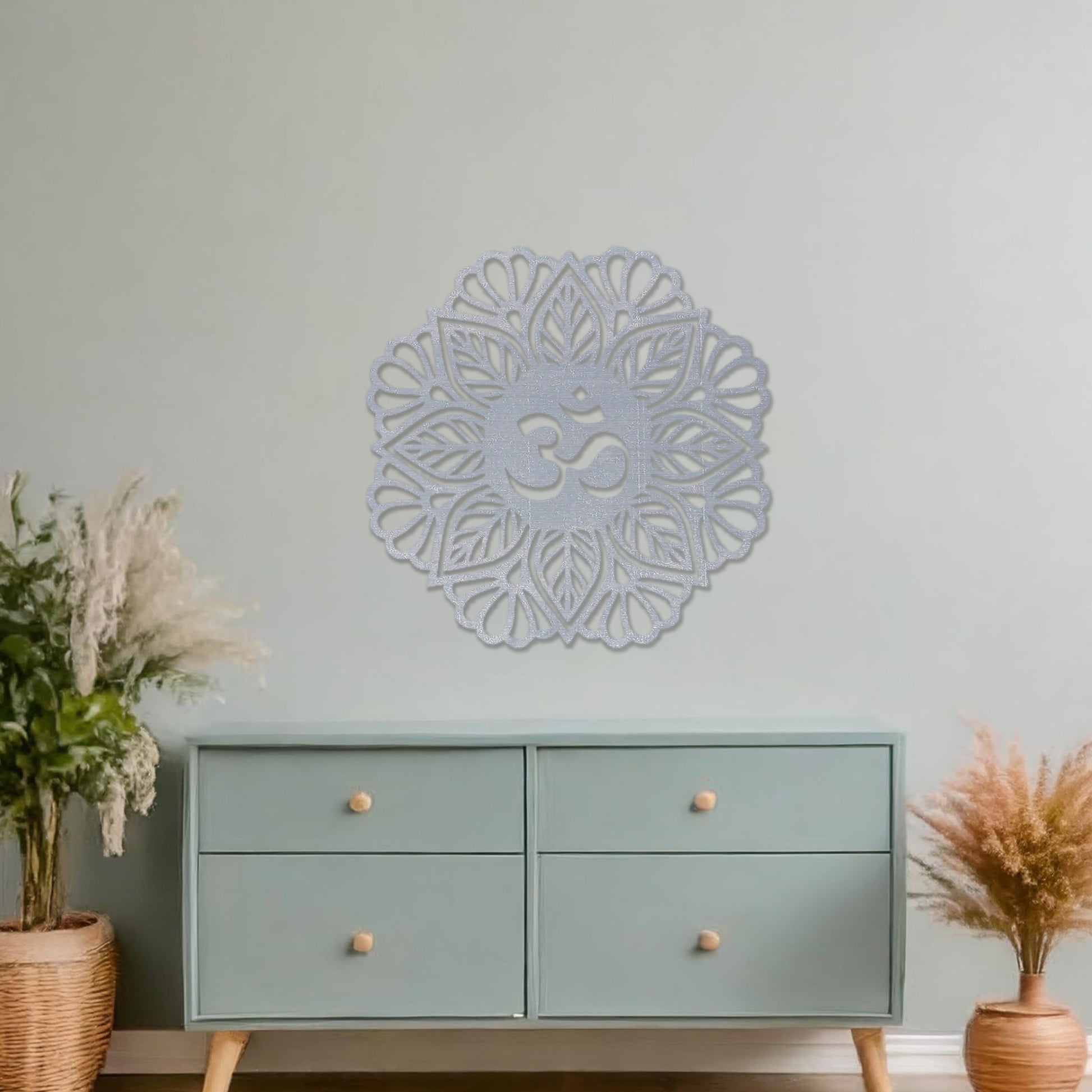 Wooden wall art featuring a mandala design with a central "Om" symbol surrounded by intricate floral and geometric patterns. The artwork is displayed on a neutral wall within modern room decor, highlighting its spiritual and artistic elegance.