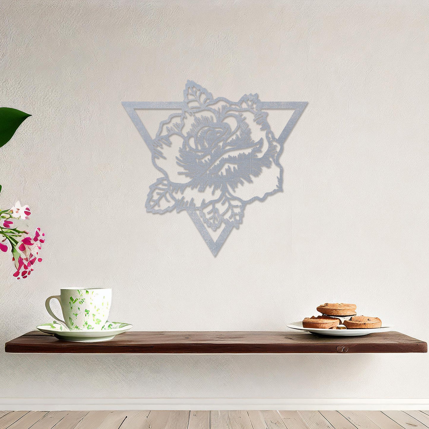 Wooden wall art featuring a rose design framed within a triangular outline, showcasing intricate detailing of petals and leaves. The artwork is displayed on a neutral wall within modern room decor, highlighting its elegant and bold aesthetic.