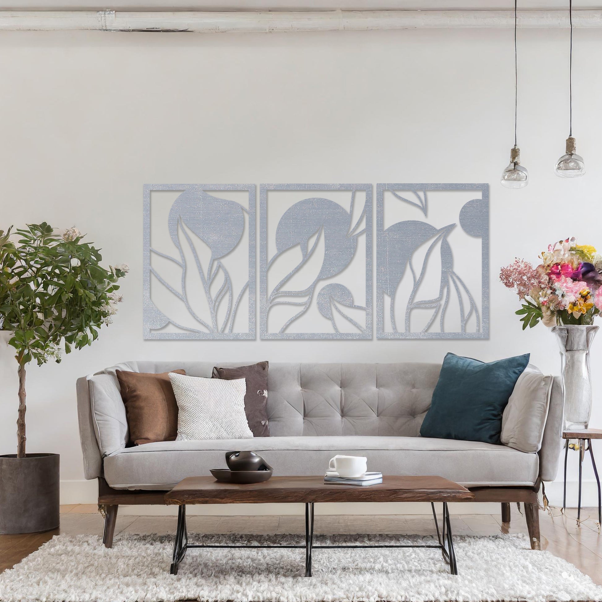 Wooden wall art design featuring a three-panel composition with abstract shapes and flowing leaves, placed on a neutral wall within modern room decor. The design blends geometric forms and natural elements for a contemporary aesthetic.