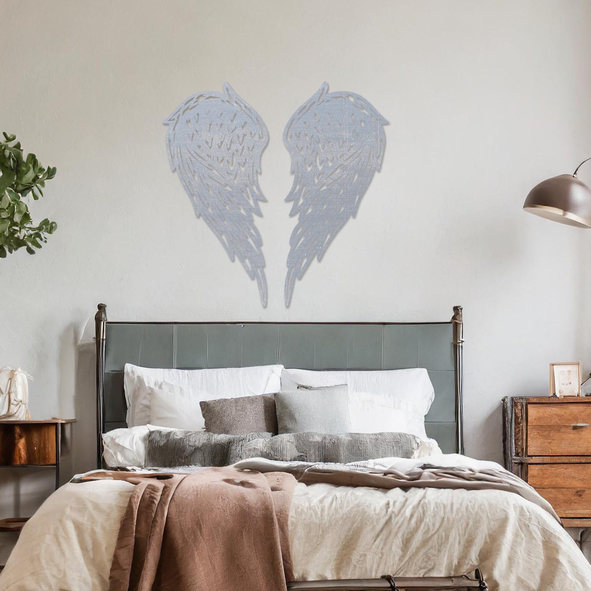 Wall art showcasing intricately designed angel wings with detailed feather patterns, displayed on a neutral wall in a modern living room. The piece adds a sense of elegance and serenity to the contemporary decor.