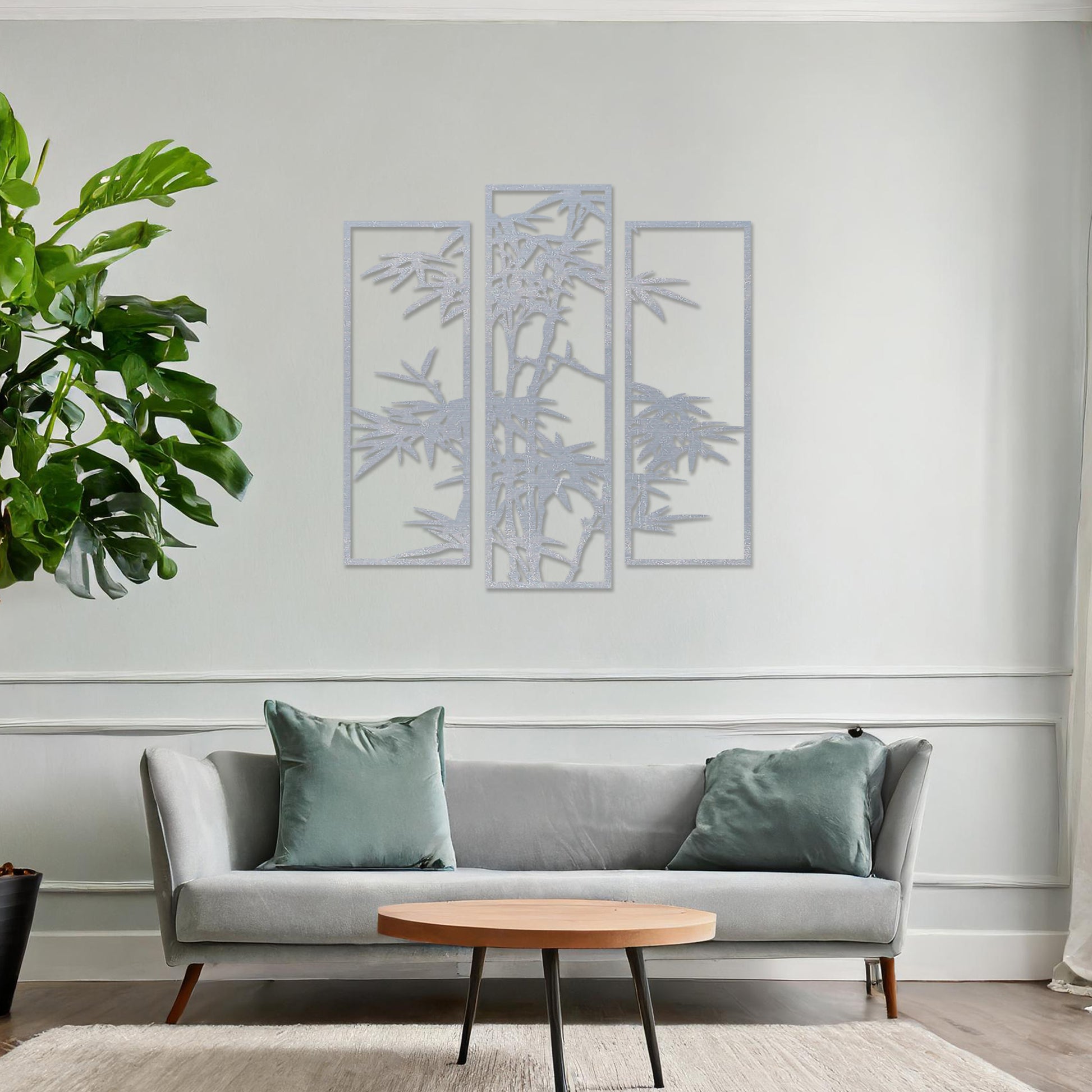 Wooden wall art consisting of three panels featuring a bamboo design with detailed leaves and stalks, displayed on a neutral wall within modern room decor, highlighting its elegant and nature-inspired craftsmanship.