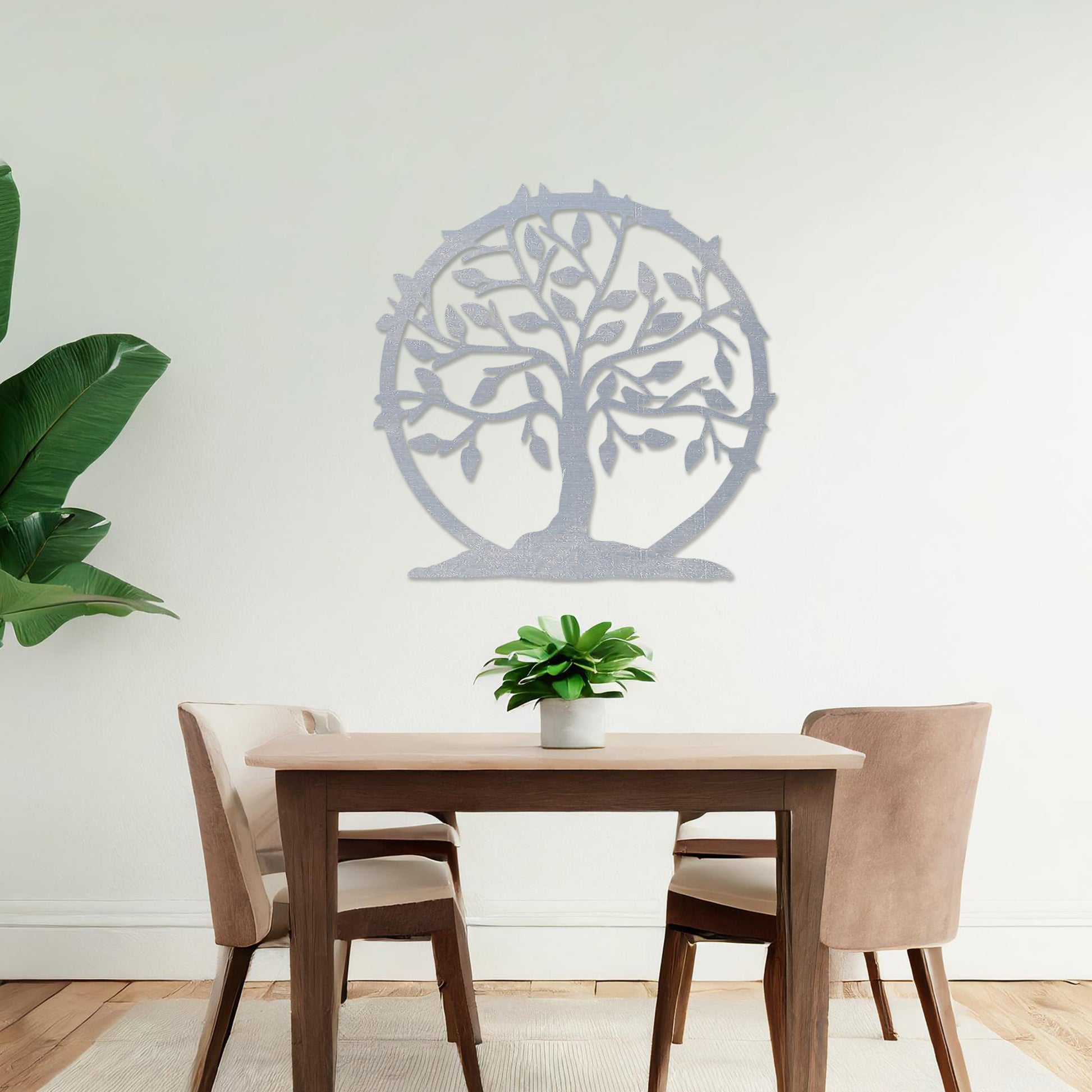 Wooden wall art featuring a circular tree design with branches, leaves, and a border of thorns. The artwork is displayed on a neutral wall within modern room decor, emphasising its natural and symbolic charm.