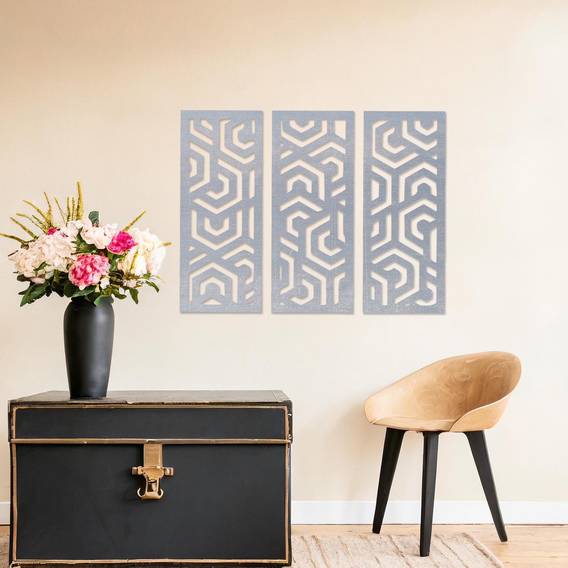 Wooden wall art featuring a three-panel design with intricate geometric patterns. The artwork is displayed on a neutral wall within modern room decor, highlighting its bold and symmetrical design.