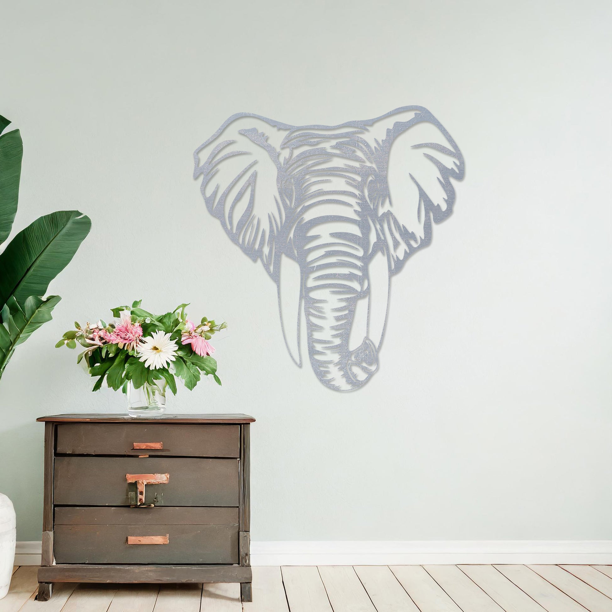 Wooden wall art featuring an intricately detailed elephant head design, displayed on a neutral wall within modern room decor, highlighting its bold and artistic craftsmanship.