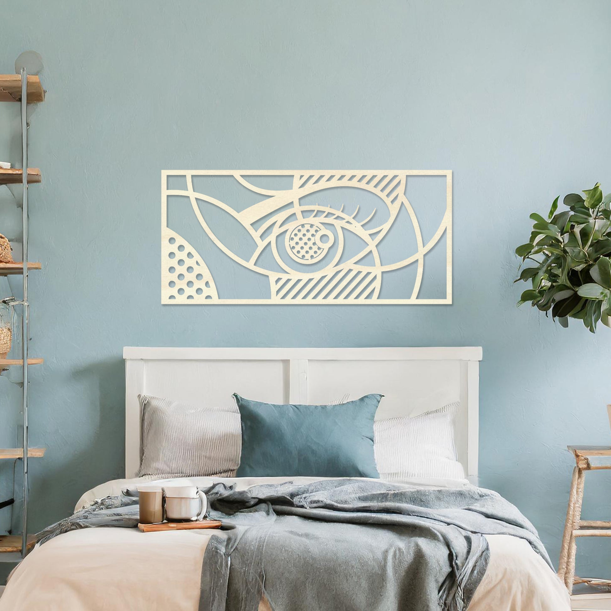 Wooden wall art design featuring a stylized eye within an abstract geometric composition, placed on a neutral wall within modern room decor. The design combines flowing lines and patterns for a contemporary, artistic look.
